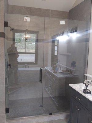 Heavy glass panel in line shower door. Clear glass, oil rubbed bronze metal with 10" ladder pull. Hilton Glass and Door 208-263-3322