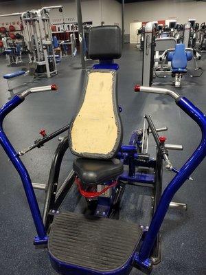 Chest press machine, seat is torn off.