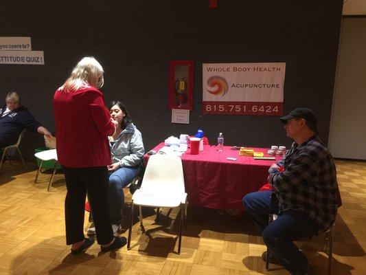 GIving acupuncture demos at the NIU health fair.