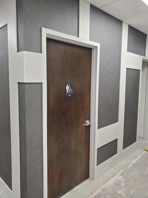 Business hallway with box look and stained doors.