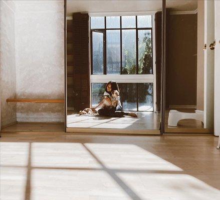 My pups & I sitting on the floor in the bedroom of apt 107. Last day there, so I opened the blinds to let the sun in.