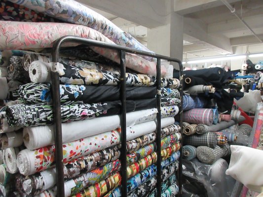 Full floor of apparel fabrics: linen, silk, cotton, wool, poly, etc.