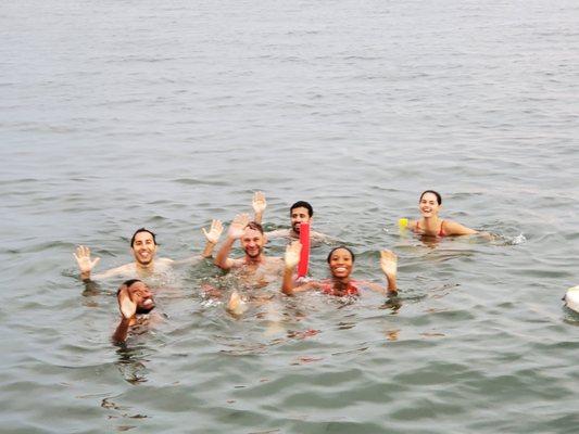 Swimming off the back of the boat.