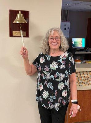 Susan ringing the bell to celebrate after her final radiation treatment!