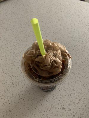 Iced coffee filled to the brim that it spilled when I put the straw in