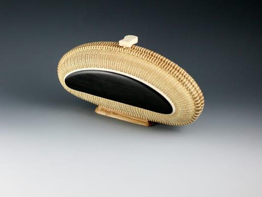 This beautiful clutch Nantucket Basket is by Michael and has ebony and ivory top on this side the other is ivory and ebony.