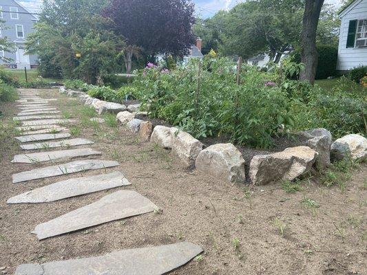 My stone walkway and raised beds they built.