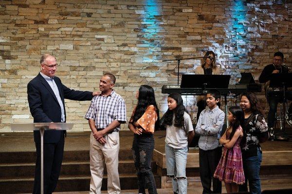 Pastor Tom honoring a family within the church