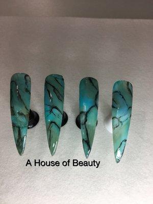 Turquoise nail art is very popular