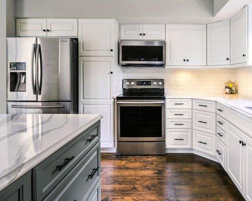 After: Cabinet refacing with Ballet White perimeter and Cityscape Island