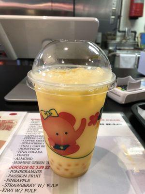 Peach bubble tea with mango popping boba