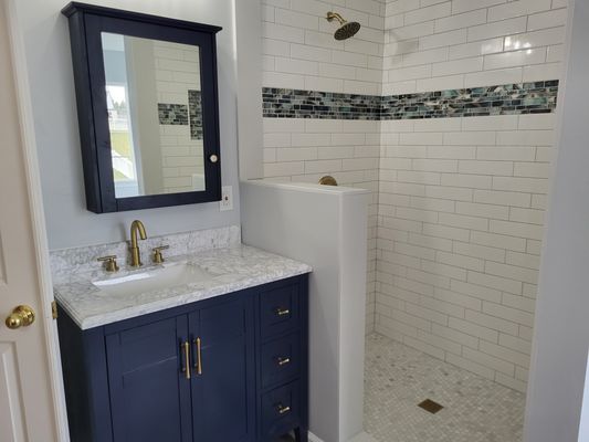 Husband's vanity and beautiful glass shower.