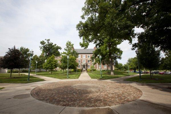 The Campus Quad is the center of a beautiful campus featuring two academic buildings and a library building.