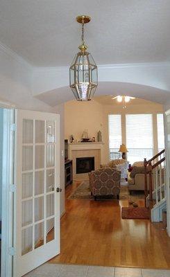 Entry way Before.. inexpensive and cheap-looking light fixture.