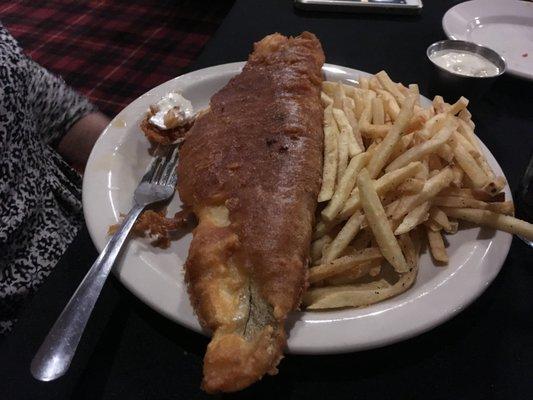 The fish fry was a wonderful golden brown, because of the lighting it looks very dark.  It was delicious.