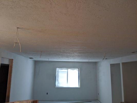 New sheetrock. Before priming and paint. Textured ceiling.