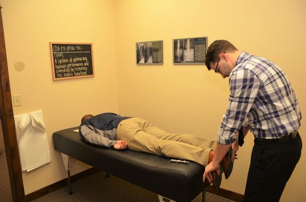 Dr. Tyler adjusts a patient in our office in Woodbury, MN. He uses a gentle, effective approach to relieve pain and realign the spine.