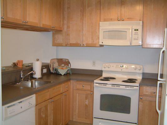 Modern kitchen includes full size appliances, built in microwave and dishwasher in all unit styles