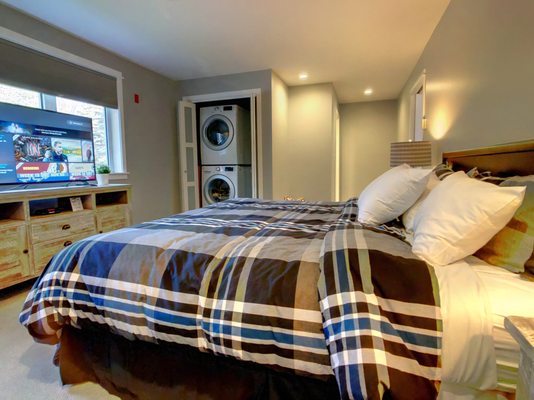 King bedroom with washer/dryer in one of our suites.