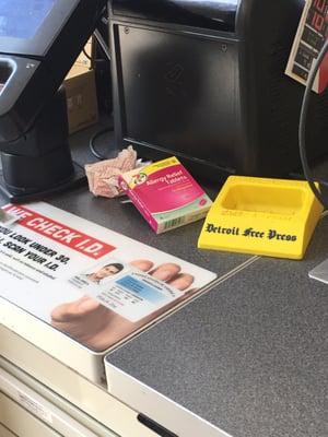 Crumpled receipt and discarded medicine box at check out counter. Just a small sample of all the garbage strewn about this store.