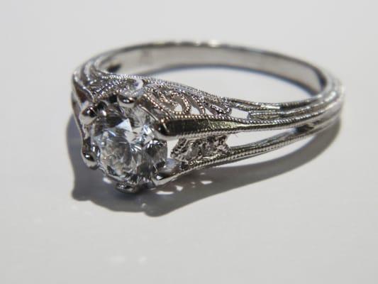 A beautiful antique-style ring with stunning milgrain filigree designs and a gorgeous center diamond.