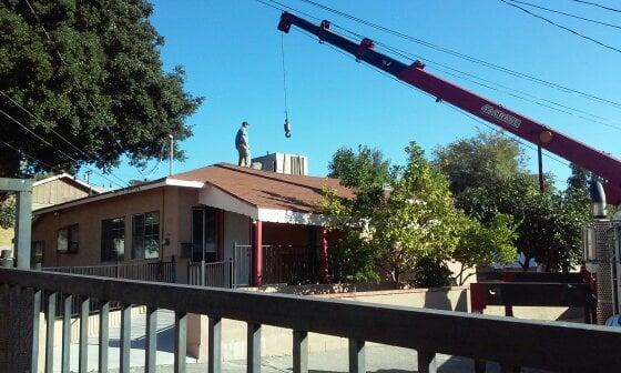 Picking an old unit off the roof so we can install a new Day and Night air conditioner.