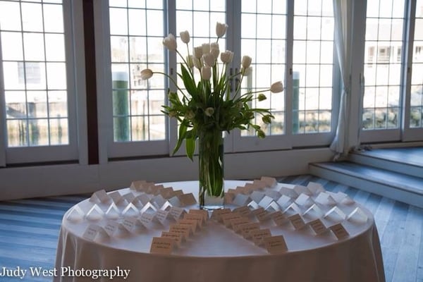 Ceremony arrangement repurposed on the place card table made by New England Gardens