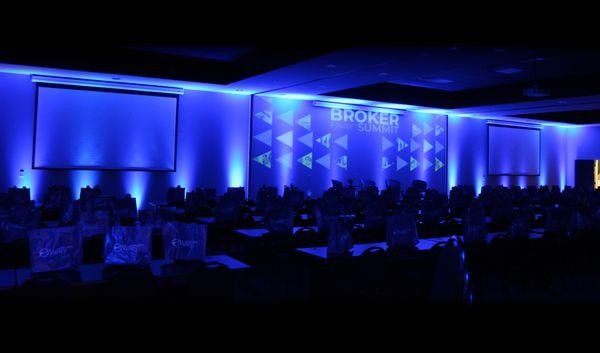 Corporate conference for Realtors Association Huntsville. Blue room lighting and video graphics