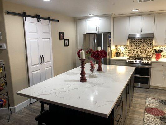 Kitchen cabinet and kitchen island install with barn door installations