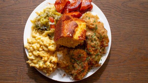 Smothered chicken tender soul food dinner! 
 Rice & gravy 
 Cabbage 
 Mac & cheese
 Candied yams 
 Cornbread