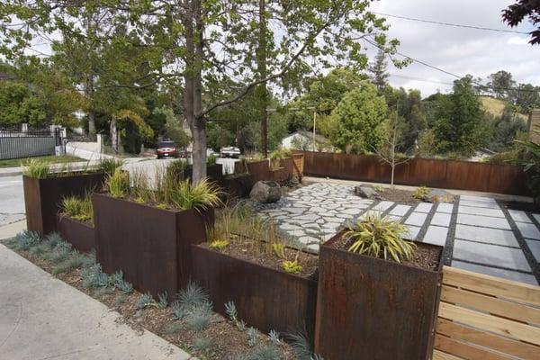 Contemporary Highland Park with custom metal planters and recycled concrete.