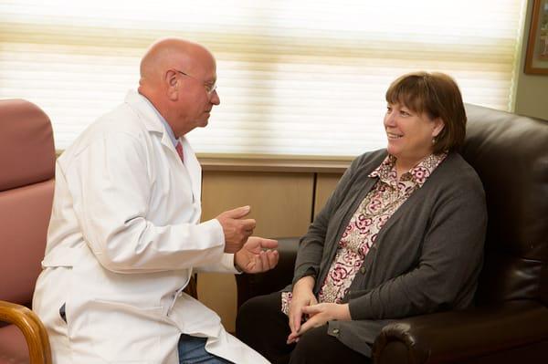 Dr. George Linhardt, general surgeon, consults with patients at Driggs Health Clinic.