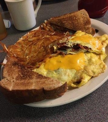 Bacon and Cheese Omelette meal, which comes with hash-browns and choice of toast--wheat toast pictured here.