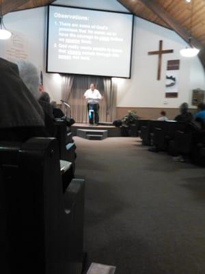 Pastor Michael Lewis preaching a sermon about the book called " The Story" it follows through the whole bible.