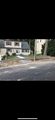 EP Henry retaining wall, with pad and new concrete walkway with boarder.