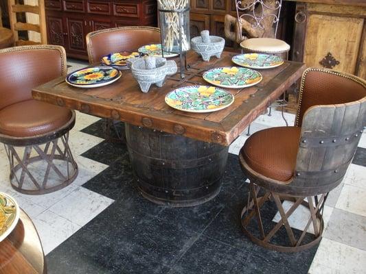 Old Tequila barrels, hand-hammered wrought iron and an old Mexican front door make up this dinning set.