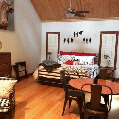 King size bed and jacuzzi tub in the Barn cottage.  High ceilings, cedar wall and skylights to observe the stars