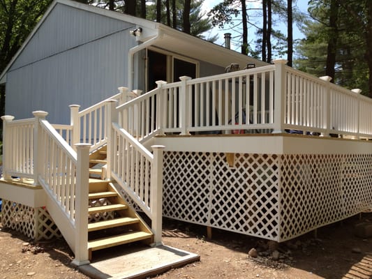 This custom deck is a beautiful addition to a summer home.