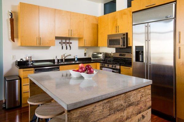 Custom island countertop. Obere matched the color to the cement condo walls perfectly! Focal point of the whole place.