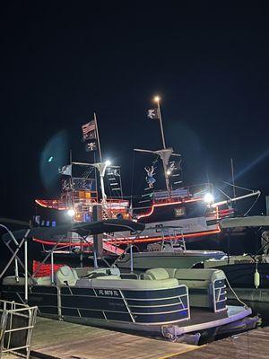 View of entire boat from a small distance away, other smaller boat in the foreground.