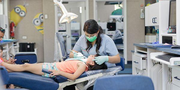 One of our dental assistants cleaning some little teeth.