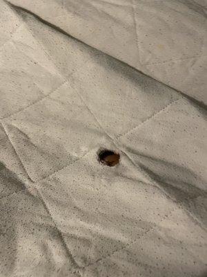 Burnt hole in sheets checking in room