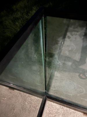 Corner gapping between glass panel. Widens as you go bottom to top.