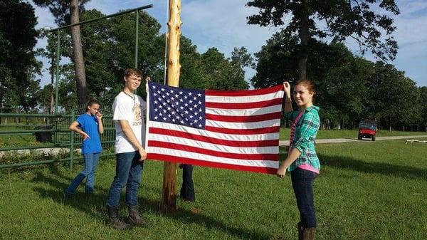 Raising the flag is an important part of the ranch experience.