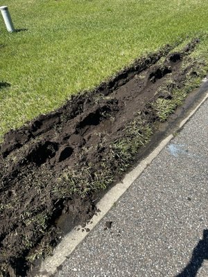 Broken sprinkler head and deep ruts. Driver left without an effort to speak with me.