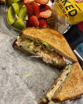 Tuna salad on whole wheat with mayo, lettuce, tomato, onion and cucumbers.