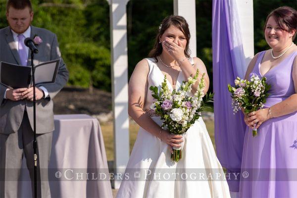 Emotional bride seeing love of her life walk down the aisle.