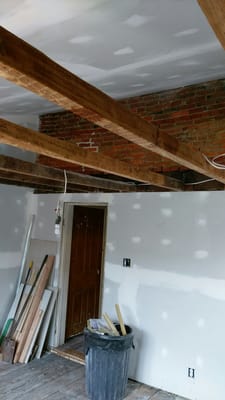 Exposed Beams and Brick Support Wall