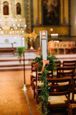 Greenery and ribbon for the aisle candles 
 
 Photo by: Trevor and Elisebeth (@trevorandelisebeth)