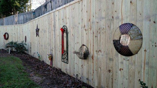 10' Tall privacy fence installed in front of an existing cinder block wall to cover the painted surface.  #HolmanFence